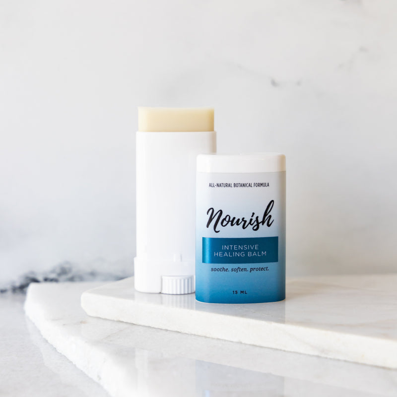 Open Intensive Healing Balm tube against a white marble background