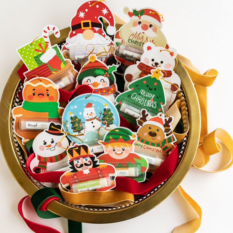 Collection of Christmas-themed stickers in a decorative box on a white background
